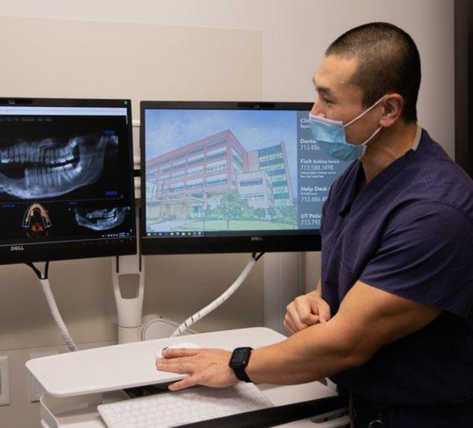 Dr. James Melville looks at an X-ray of Grace Moss' jaw. Dr. James Melville looks at an X-ray of Grace Moss' jaw.